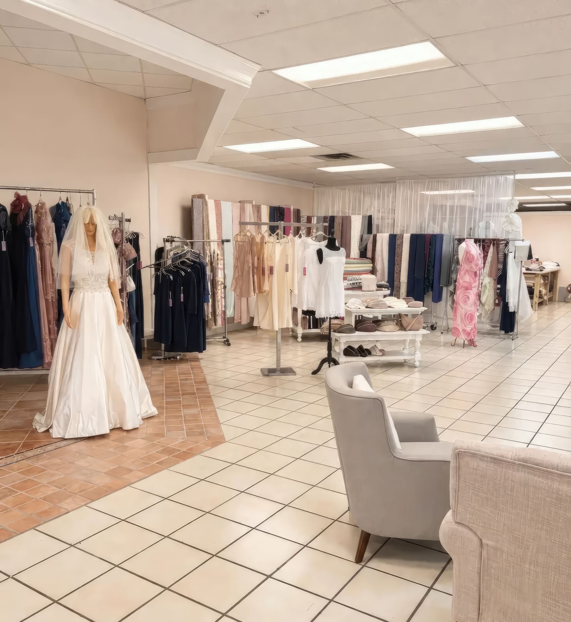 Inside Margaryta’s Dress Studio: a wedding gown on display, racks of evening dresses and fabrics, and a seating area for fittings